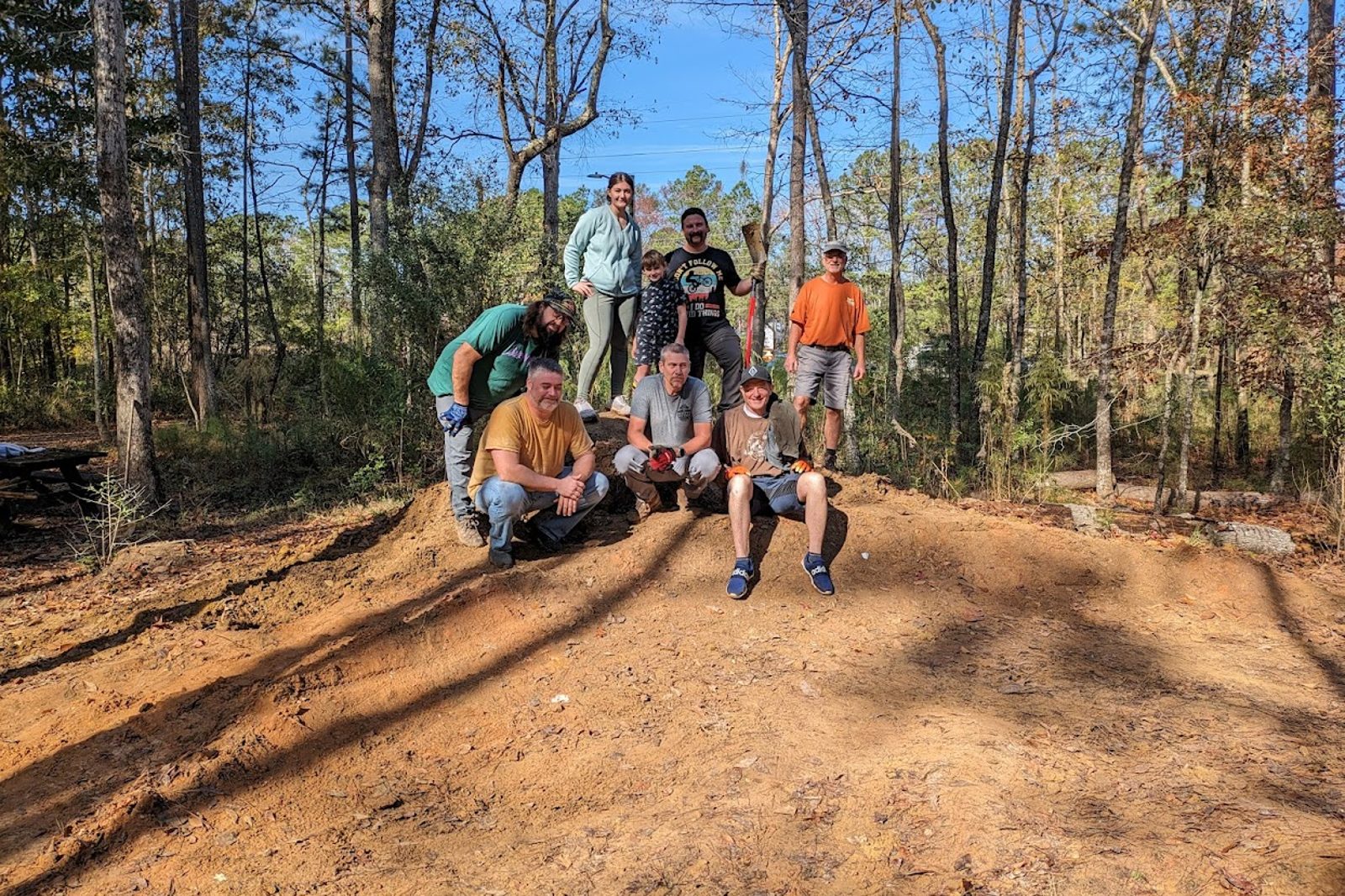 Volunteers posing on a newly built trail feature